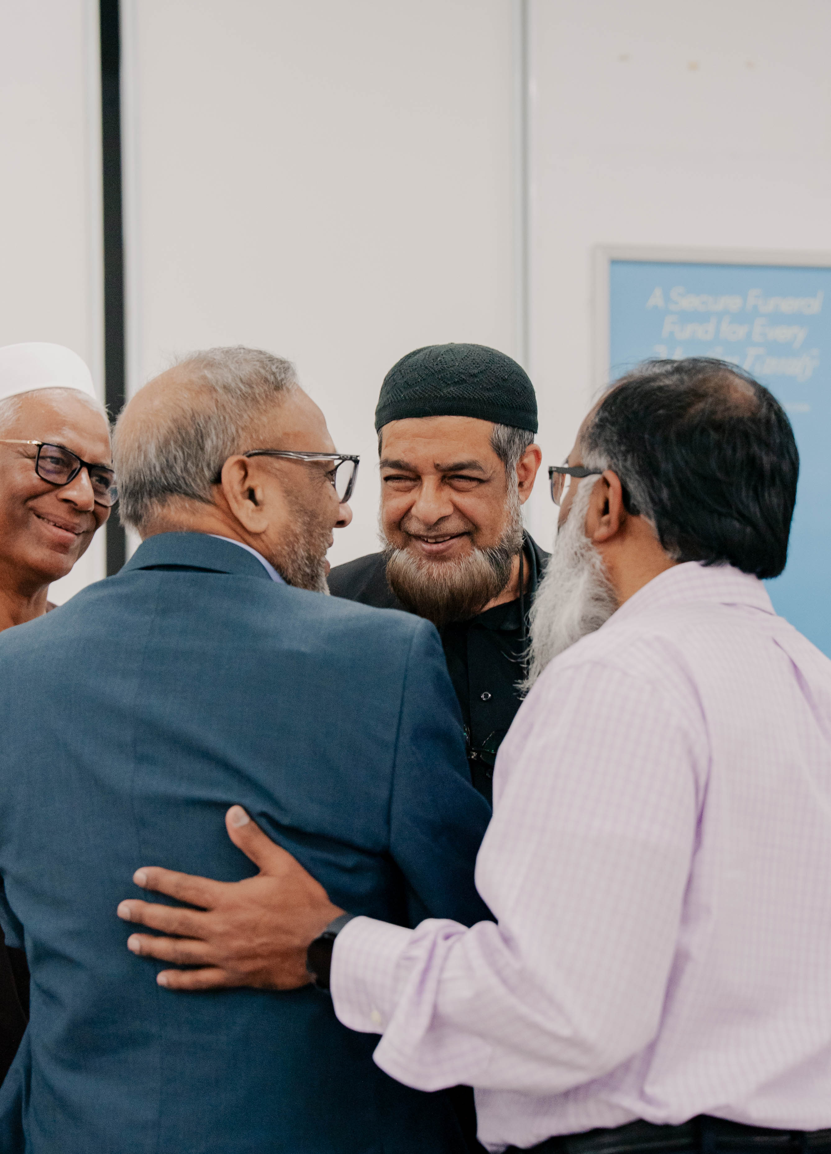 Members of the Gallipoli Funeral Fund community embracing and greeting one another at the fund's launch